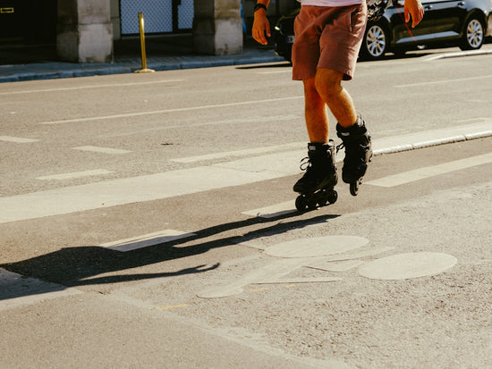 man in black leather boots and red shorts running on road during daytime