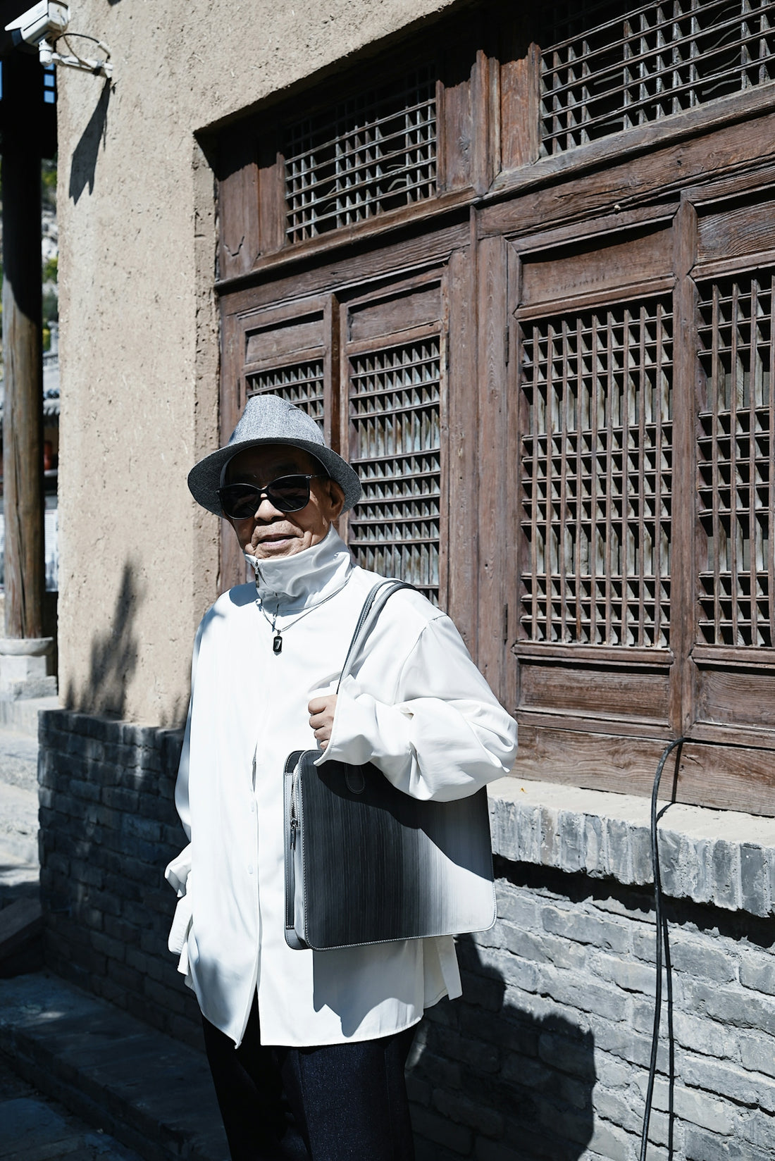 a person wearing a hat and sunglasses