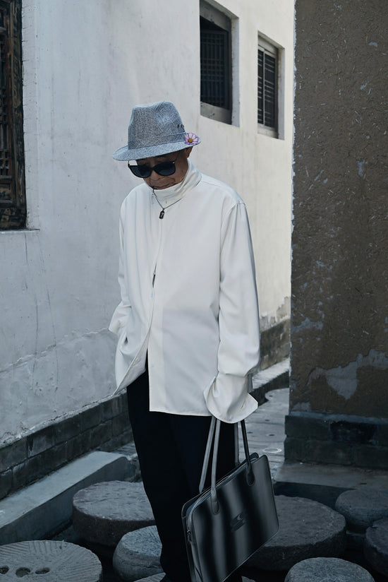 a man wearing a hat and sunglasses