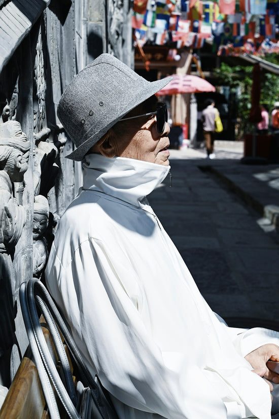 a person wearing a white robe and a hat