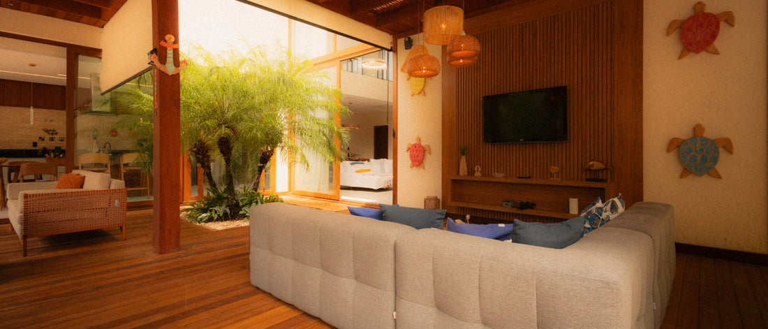 Living room with sofa, tv, and indoor plants.