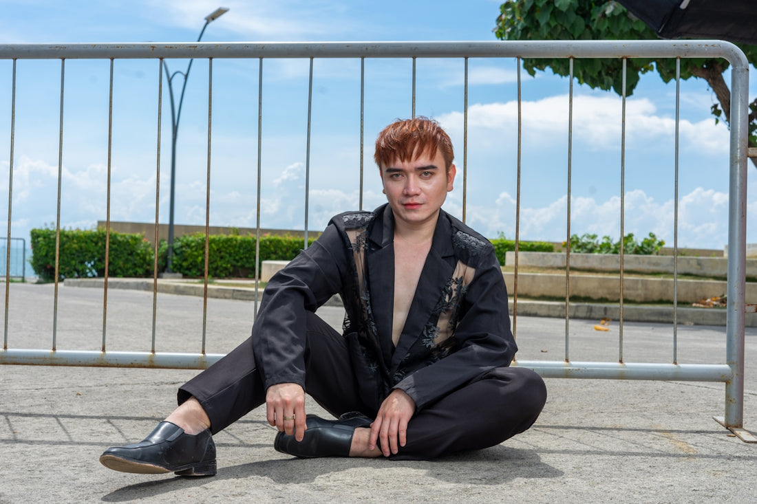 Young man with red hair sitting outdoors