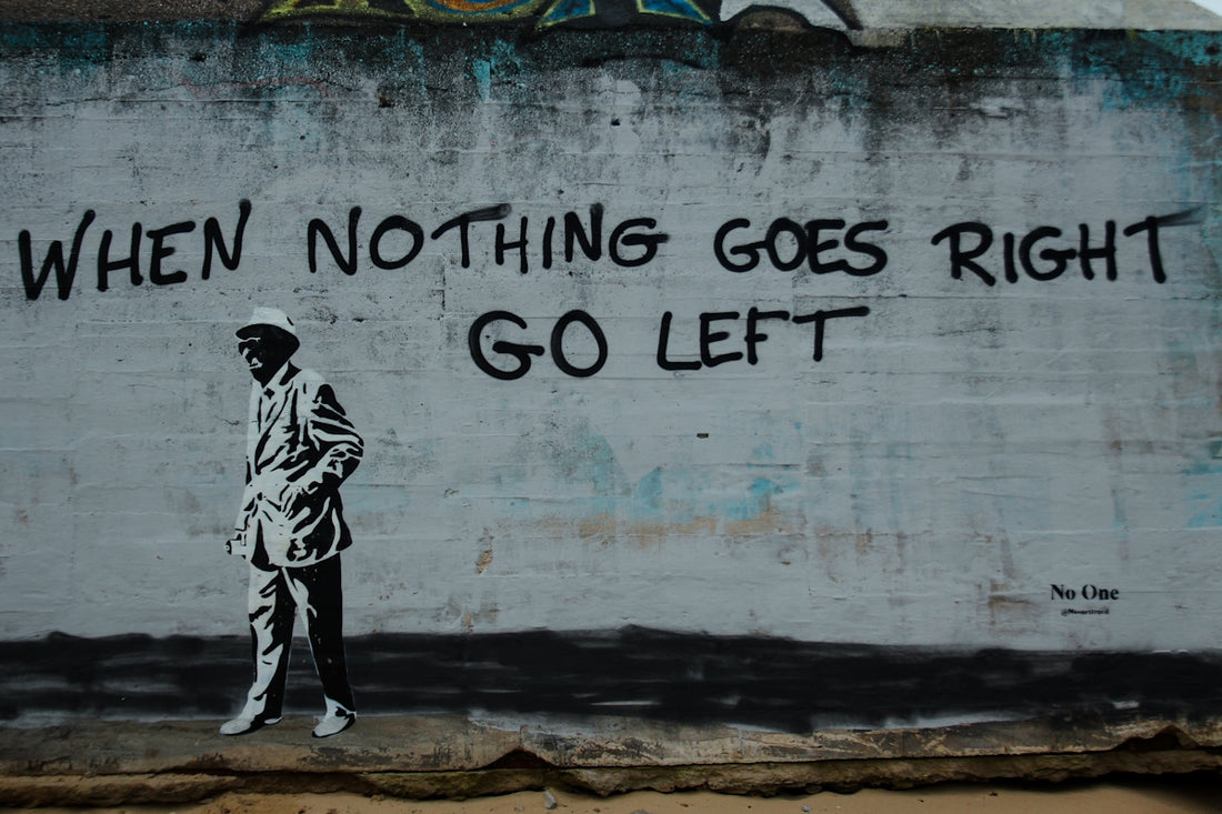 Graffiti on a wall with a man walking