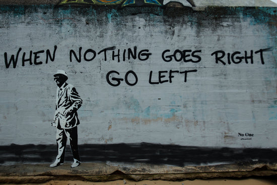 Graffiti on a wall with a man walking