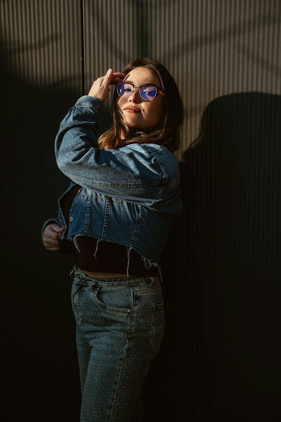 Young woman in denim jacket and sparkling pants