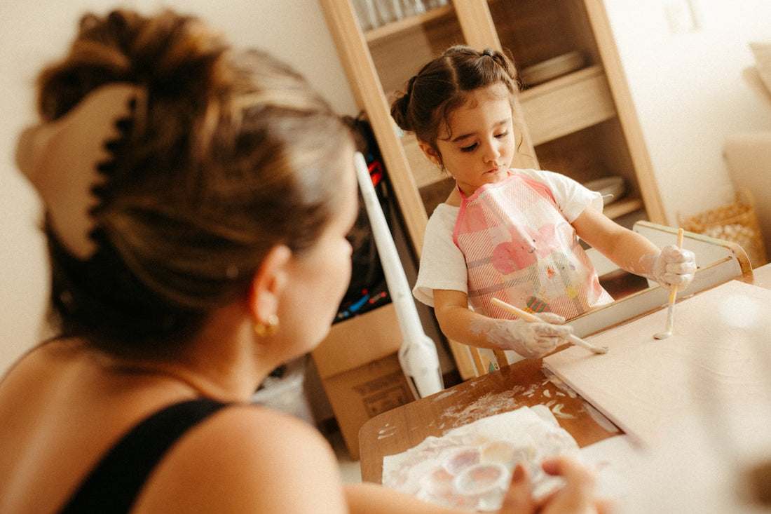 A mother watches her child making cookies