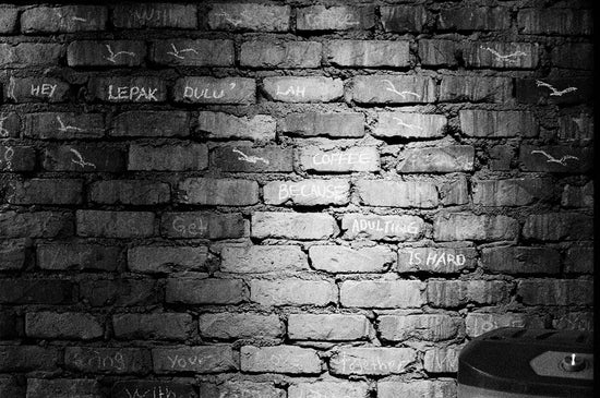 Graffiti on a brick wall with light shadows